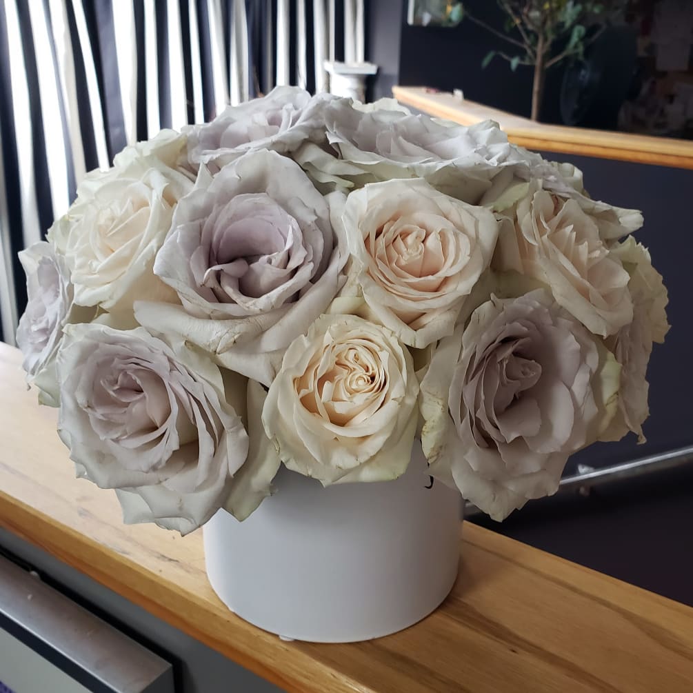 2 dozen gorgeous soft roses in a white round container. 