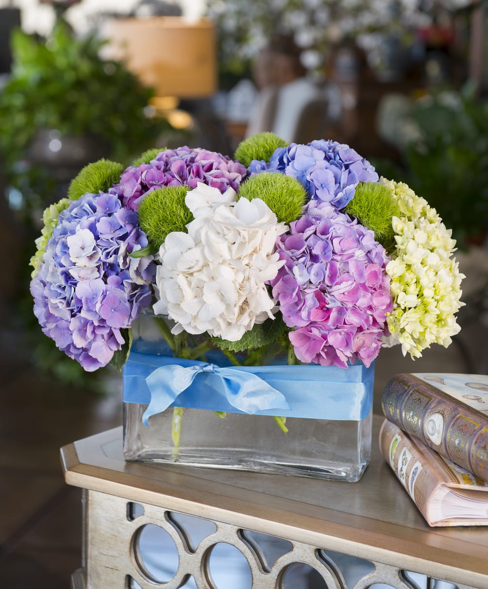 Green, blue, white and lavender hydrangea with moss balls make up this
