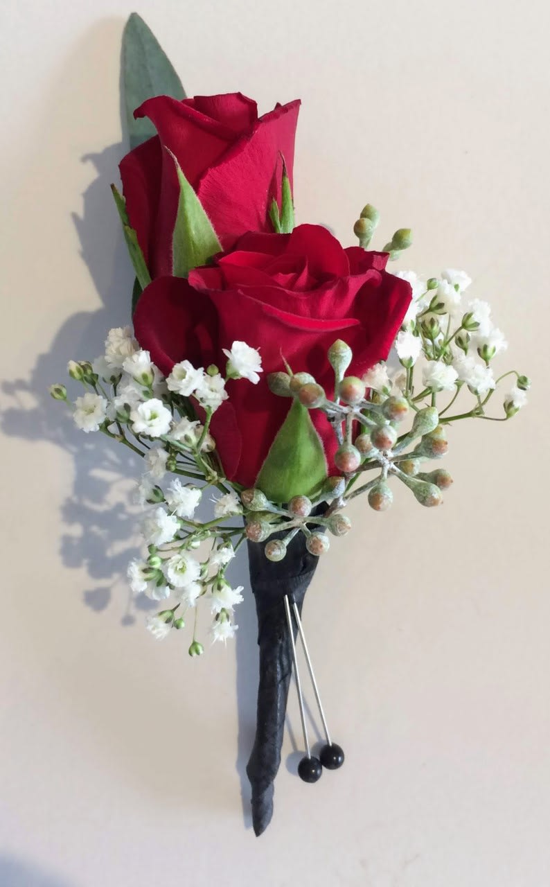 Look sharp with a simply stylish red rose boutonniere.