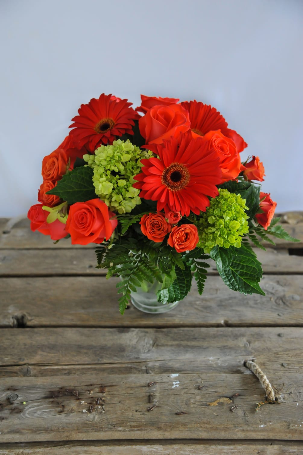 A bold and beautiful bubble bowl of gerbera daisies, roses, and hydrangeas.