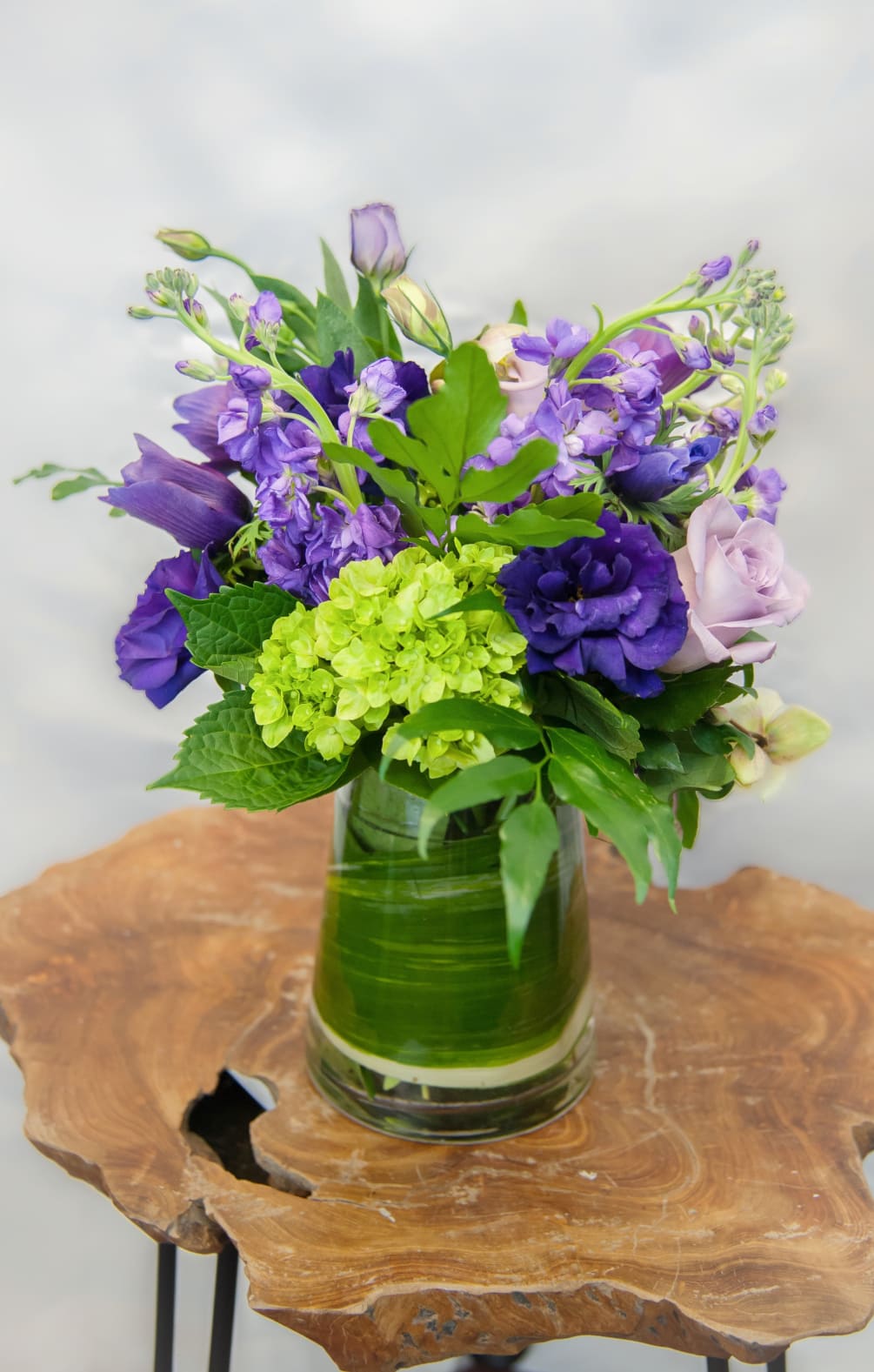 Beautiful purple anemones, green hydrangea, and stock provides a beautiful as well
