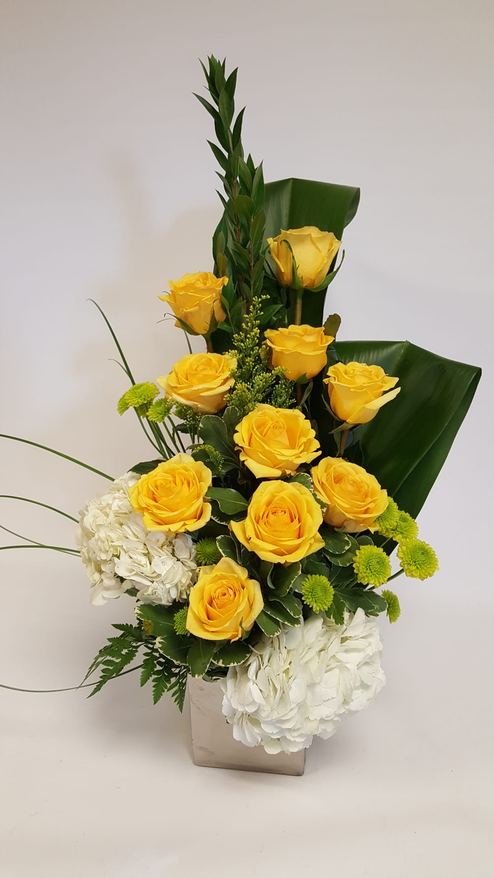yellow roses hydrangea green poms and ti leaf