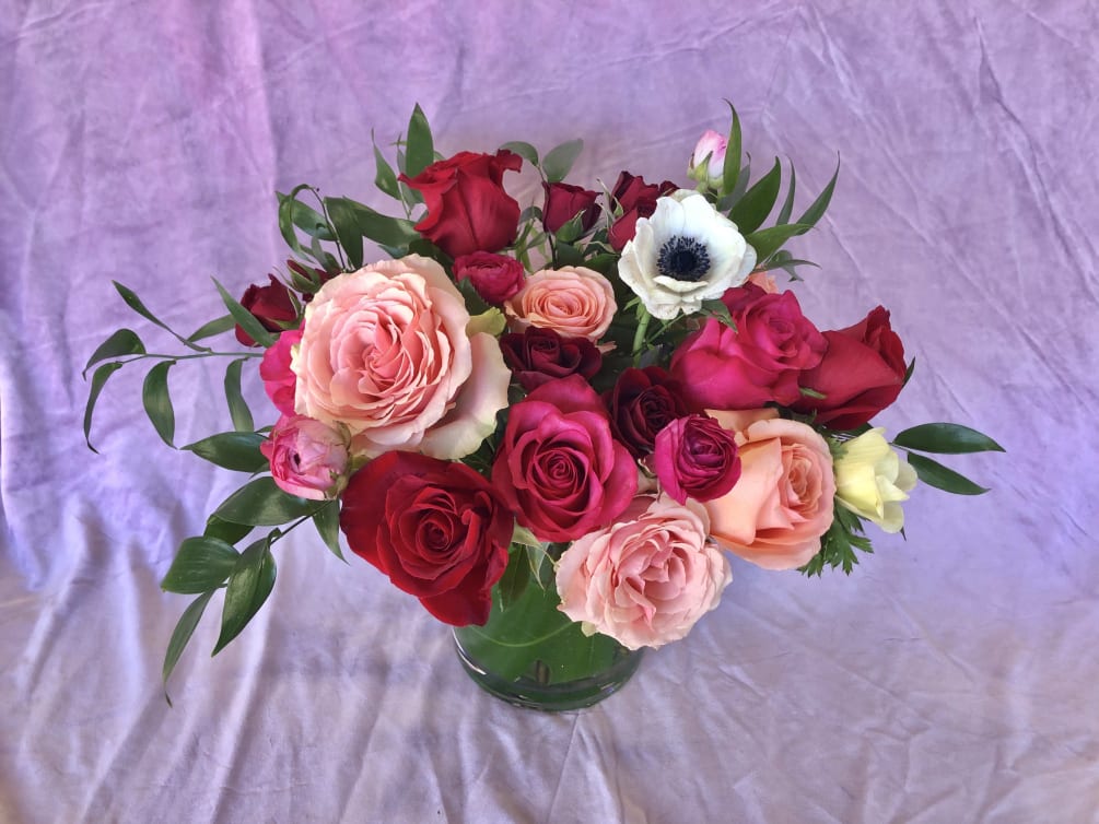 This garden style, red pink and white floral arrangement is sure to