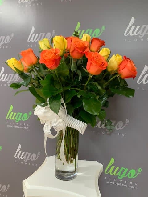 24 Roses mixed Orange N Yellow combined with some green accents and
