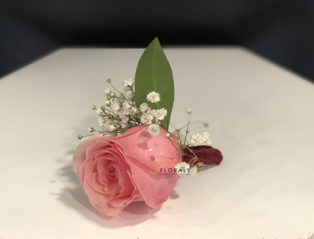 A pink rose with baby breath. The perfect rose to fit on