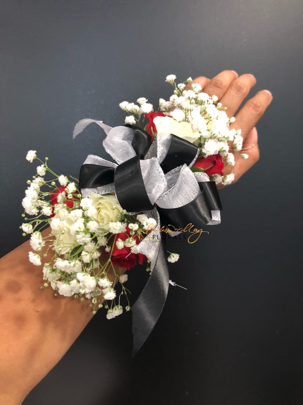 The perfect corsage for a prom date . It has black and