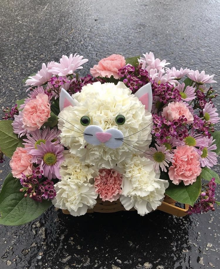 A cat made out of flowers 
