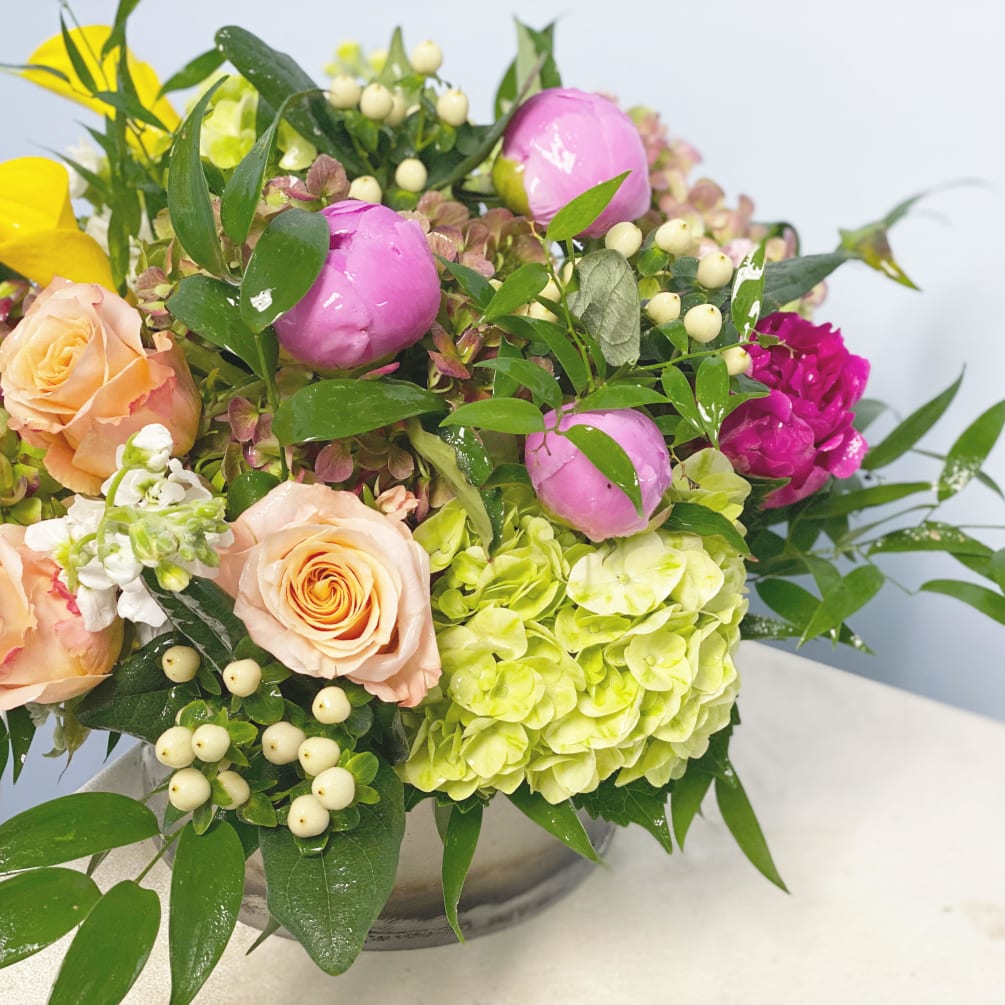 This design is overflowing with high end blooms. Perfect for sending a