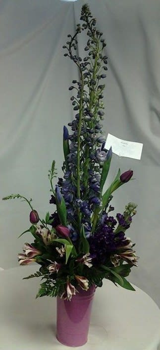 This arrangement is done in shade of purples for light to dark.