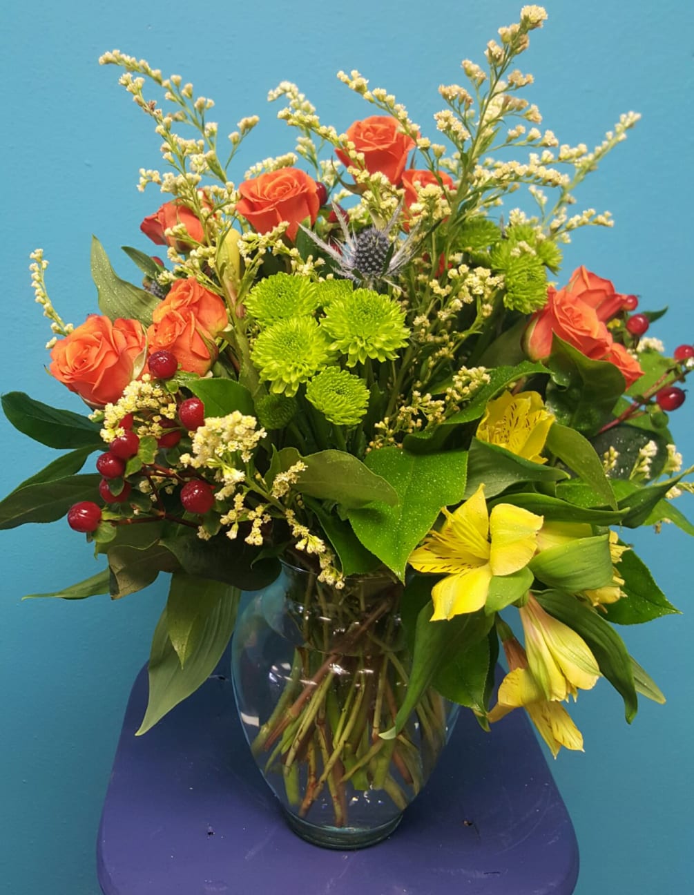 A mixture of fall colored spray roses, alstroemeria, solidago, pomps, thistle and