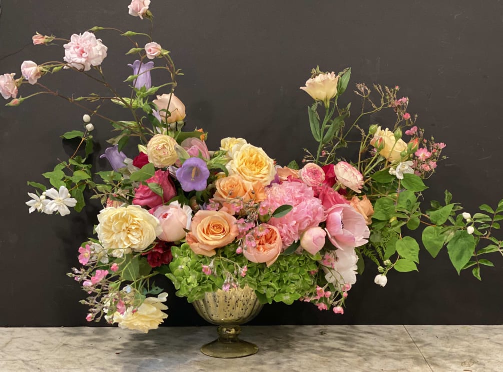 A lush and wild floral arrangement that highlights the magical seasonal offerings