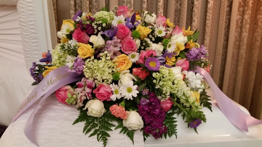 A beautiful tribute combining several different flower varieties. We can add or