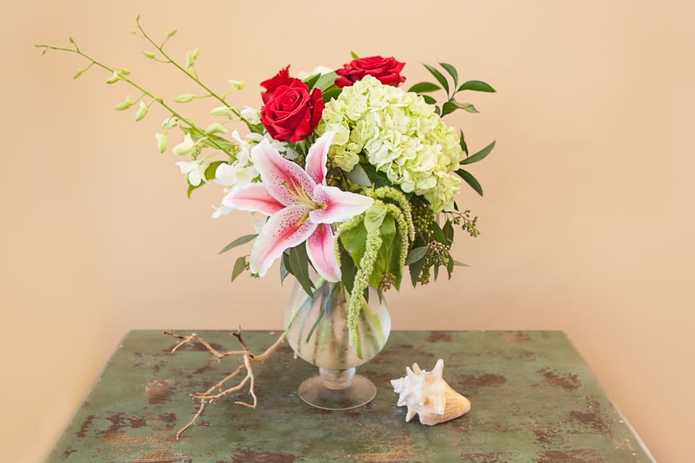 A romantic combination of roses, oriental lilies, white dendrobium orchids, hydrangea and