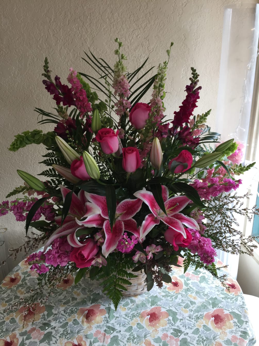 beautiful basket full of pink lilies, roses, stock, snapdragons to brighten anyone&#039;s