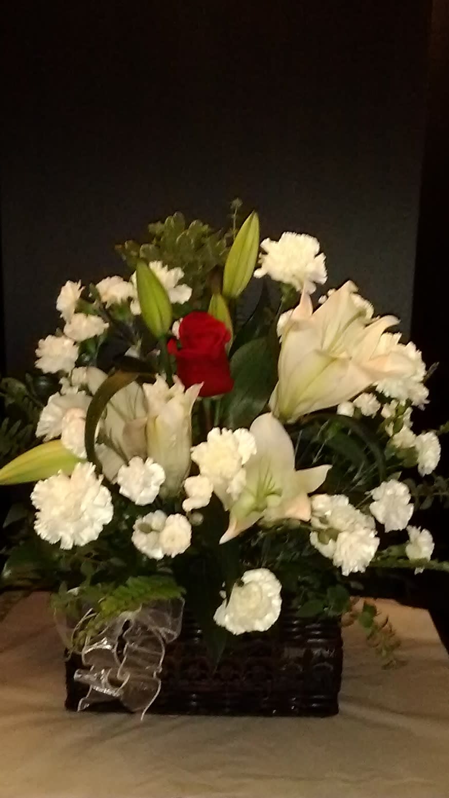 White lily, White carnations arranged in a square basket with a red