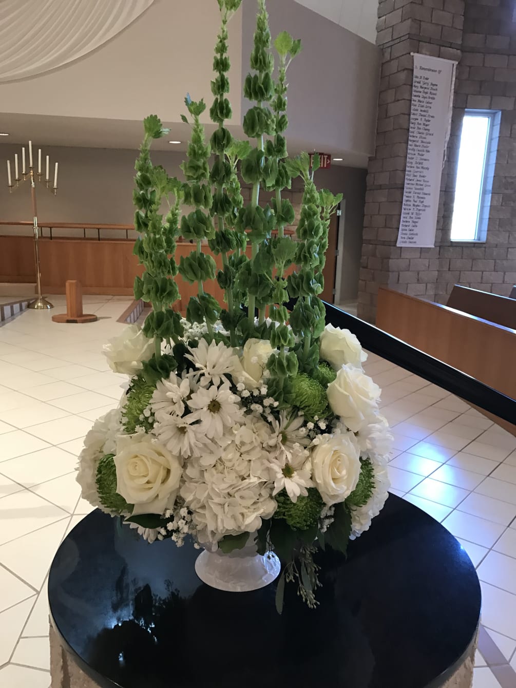 This arrangement is beautiful and used at the wedding ceremony. Bell of