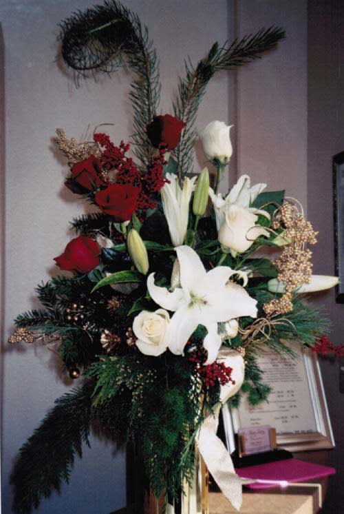 holiday colored vase with roses, fragrant lilies and so much more. Vase