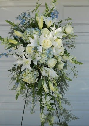 Soft blue and white arrangement on an easel is suitable for a