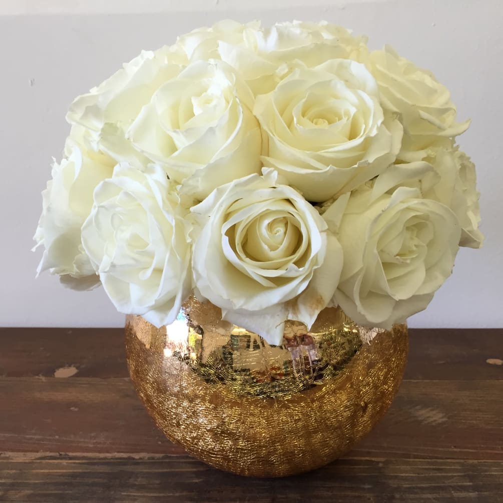 This Gold bowl is filled with Two Dozen White Roses. The perfect