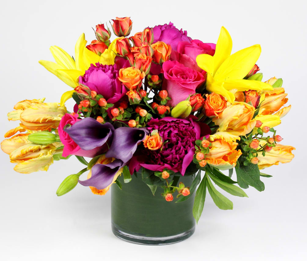 This color explosion is filled with Asiatic Lilies, Roses, Hypericum, Peonies, Parrot