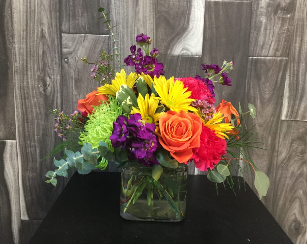 Turn up the heat with the vivacious bouquet. This arrangement includes roses