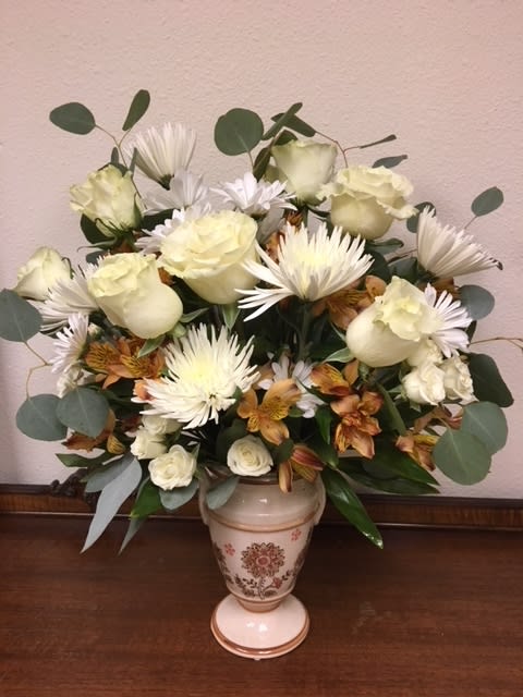 Blooms that will bring joy and last.  Pedestal vase varies with