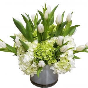 Tulips and Hydrangeas in a cylinder vase.  Simply stunning.  Color
