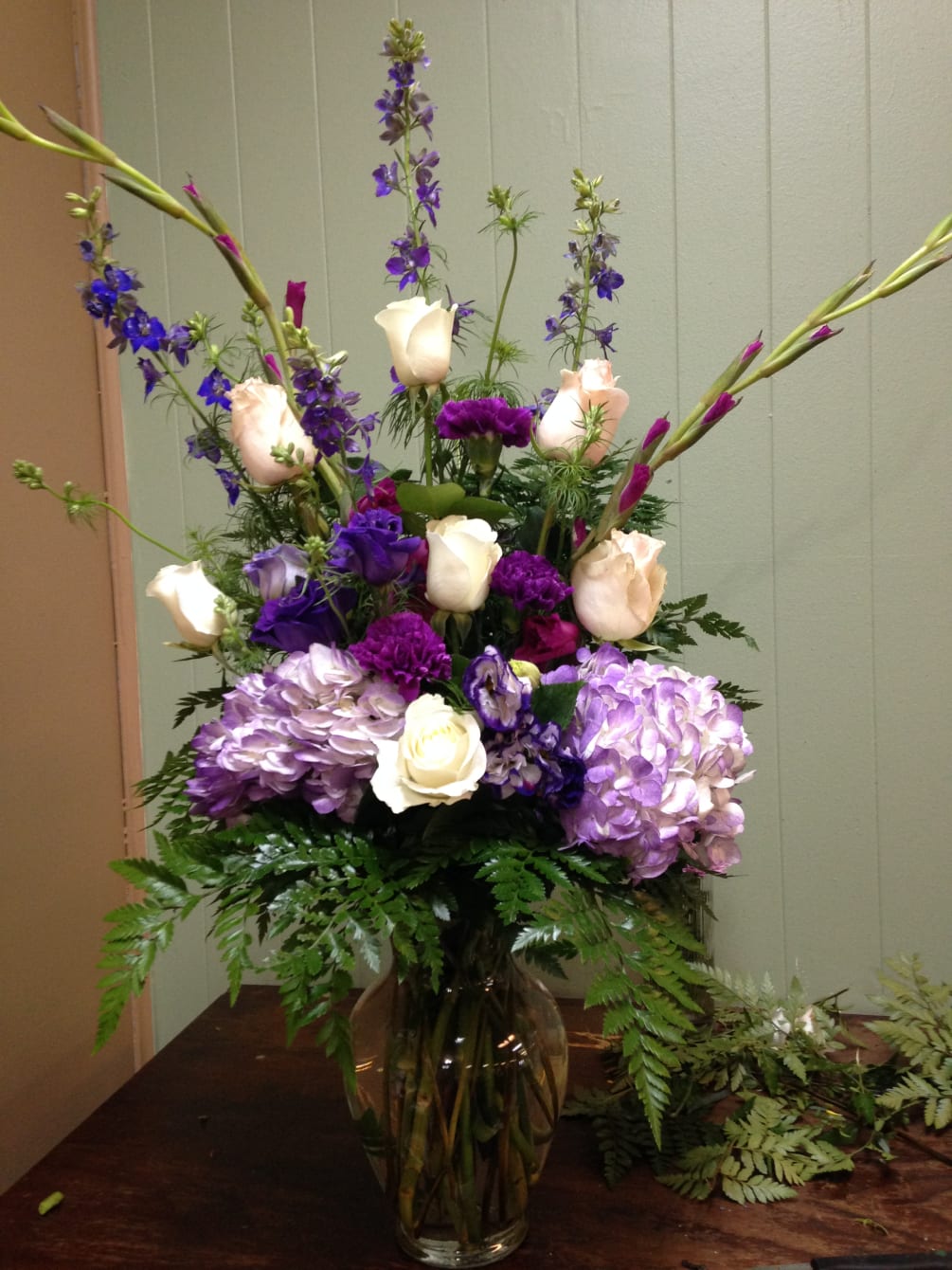Purple Hydrangeas, purple larkspur, purple gladiolas, white roses,  purple carnations and