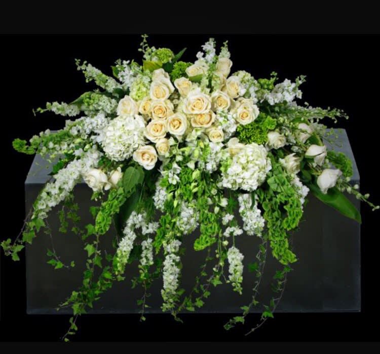 An amazing tribute piece for the casket. Soft white blooms in a