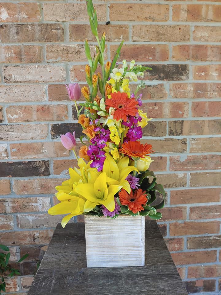 Beautiful Bright Blooms arranged in a wooden cube. 