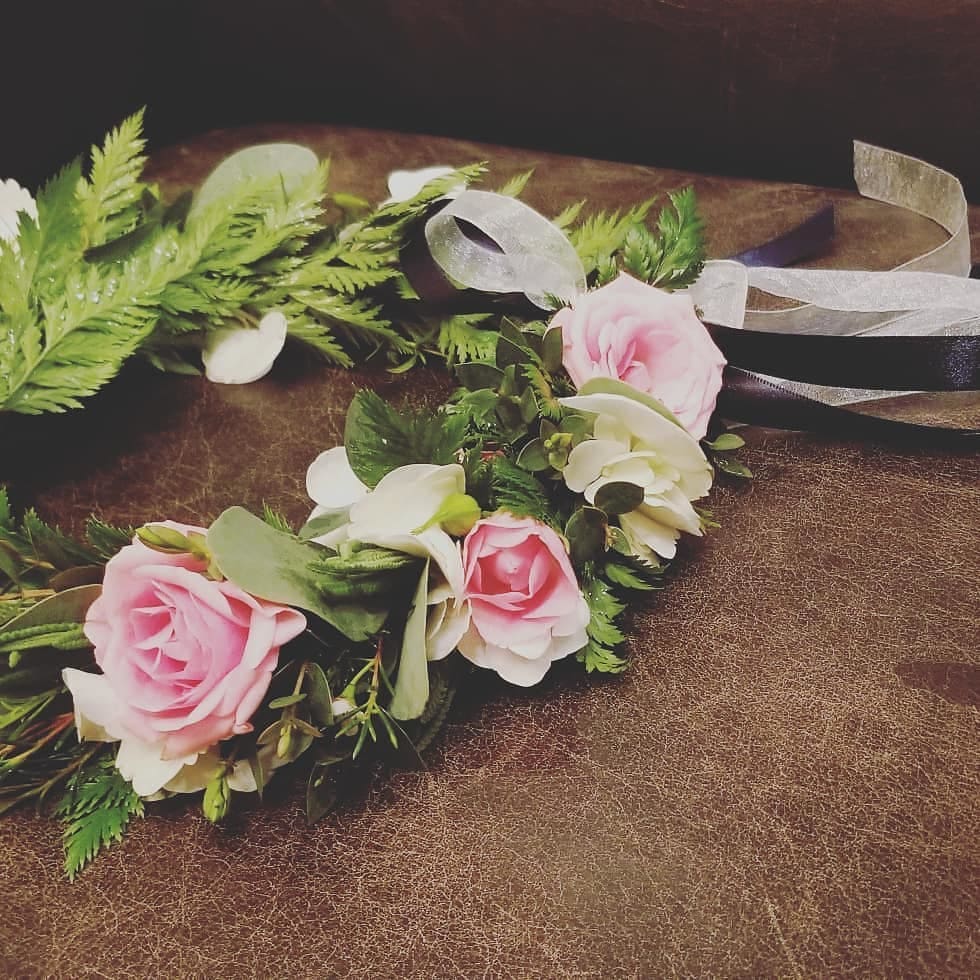 Soft pink roses, eucalyptus and garden accents. Ribbon color your choice. 