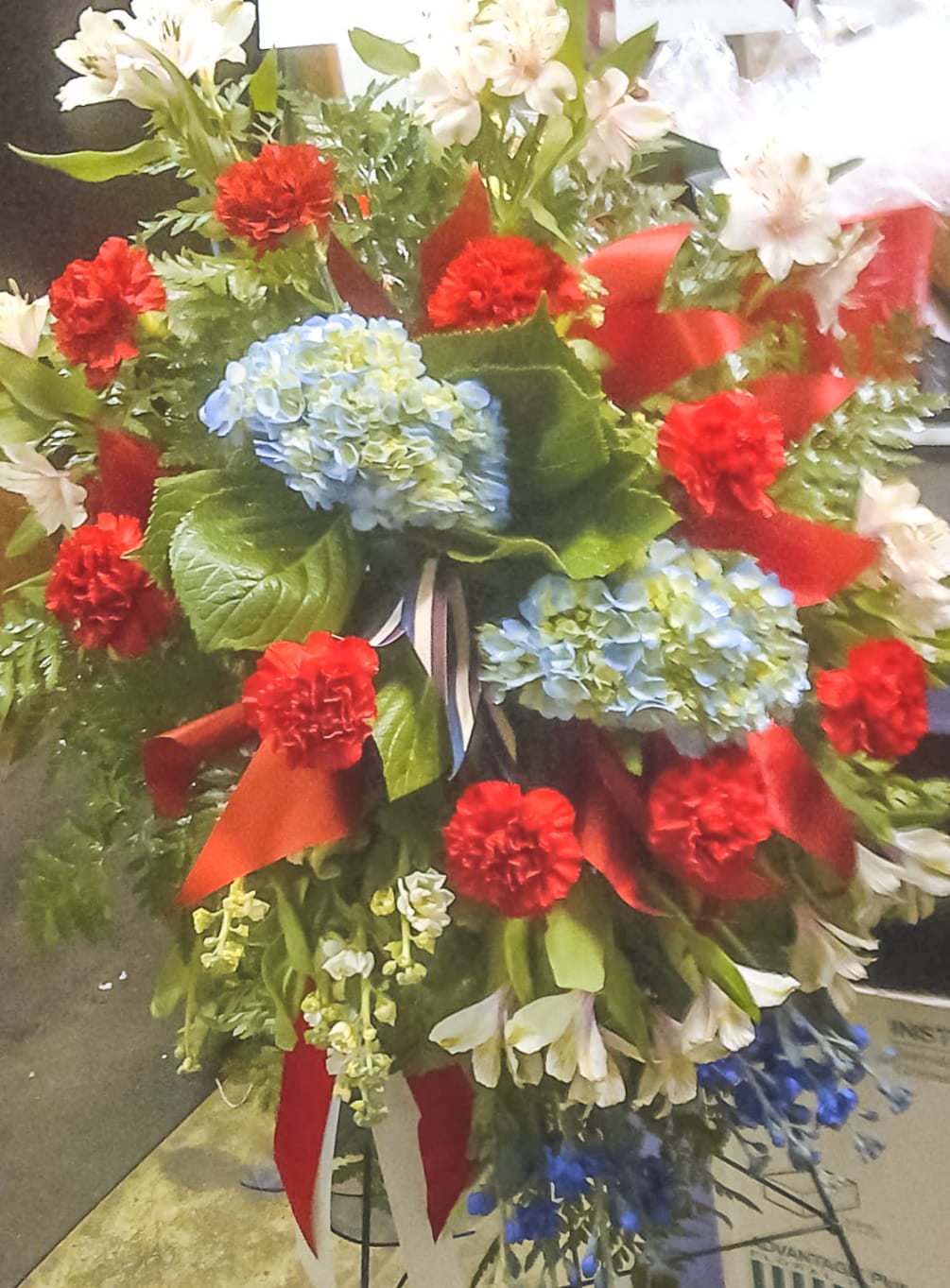 Beautiful standing spray featuring Carnations, Alstroemeria, Delphinium, Stock and various filler with