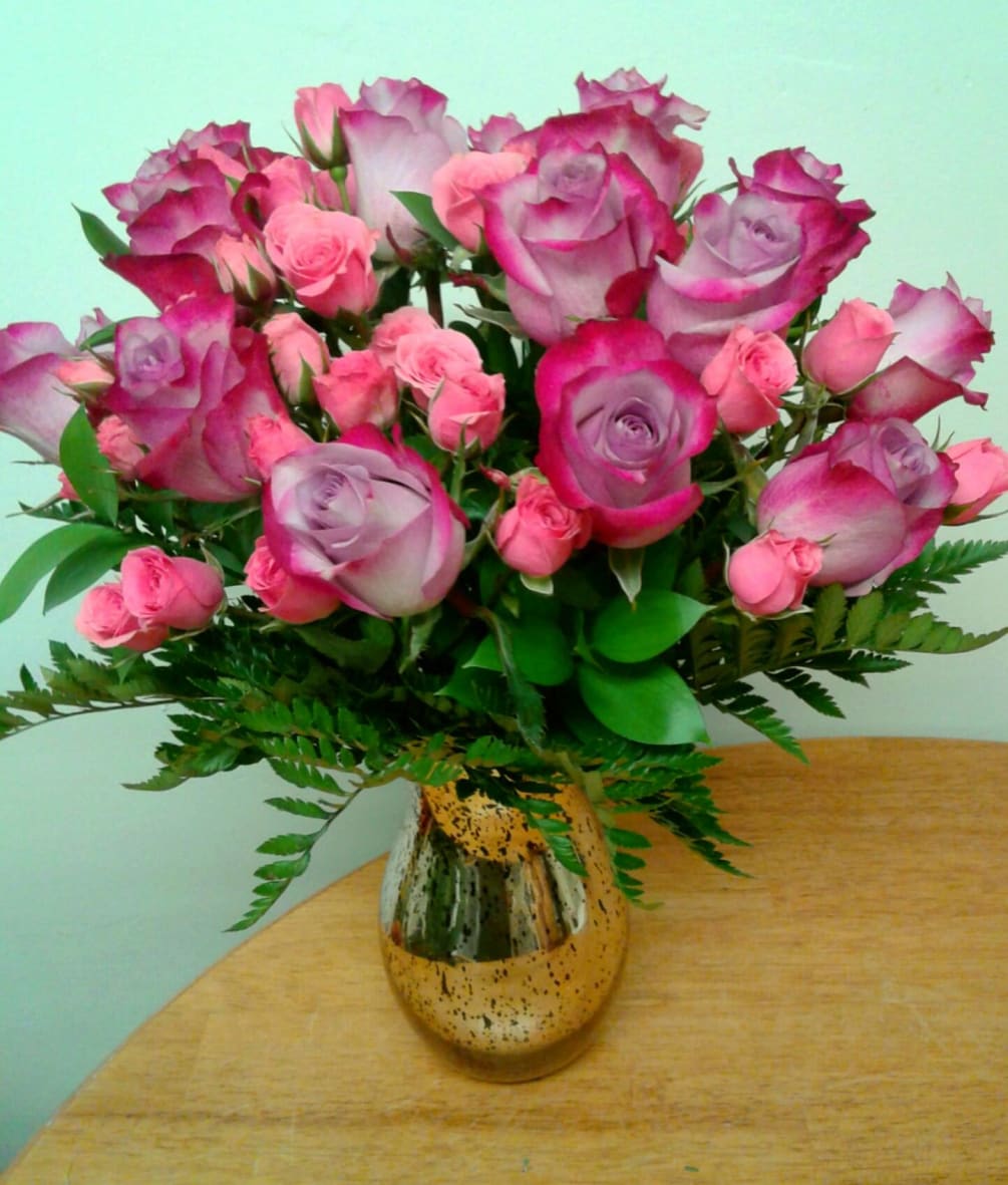 Lovely Lavender Roses and Hot Pink Spray Roses arranged all around in