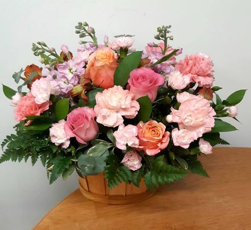 A delicious combination of peach roses, pink larkspur, pink roses, orange alstroemeria