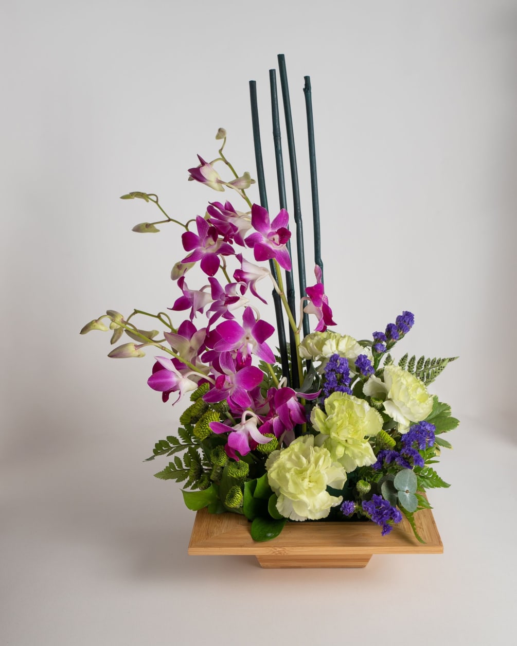 A dazzling display of Dendrobium Orchids in a bed of complimentary flowers.