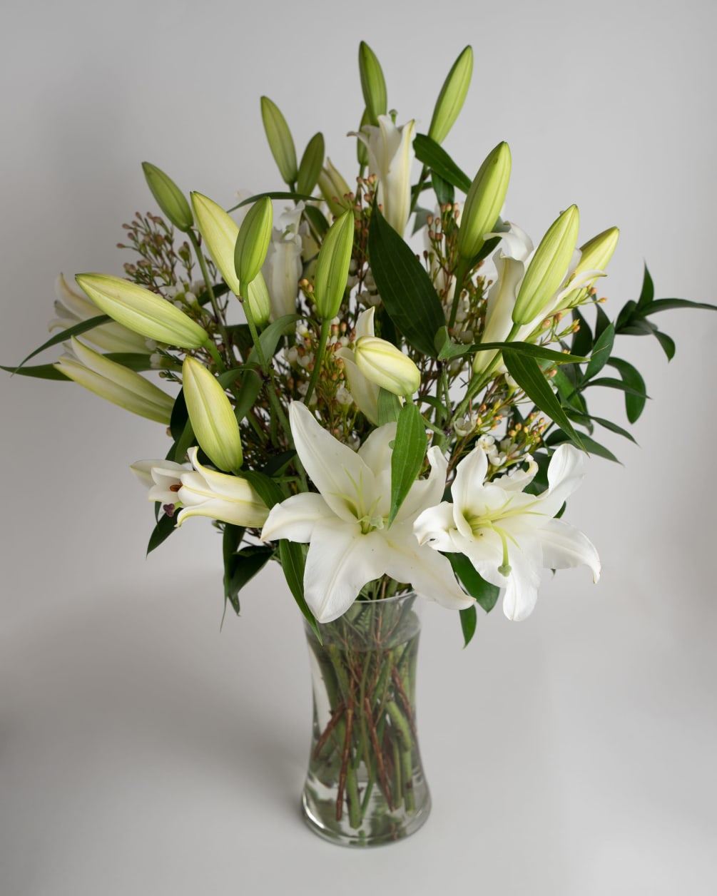 White Orients Lilies arranged tall.