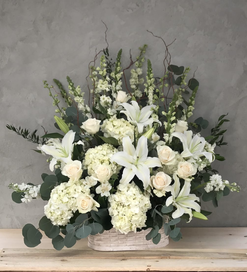 A 32&quot; x 32&quot; sympathy arrangement of white flowers, such as hydrangea