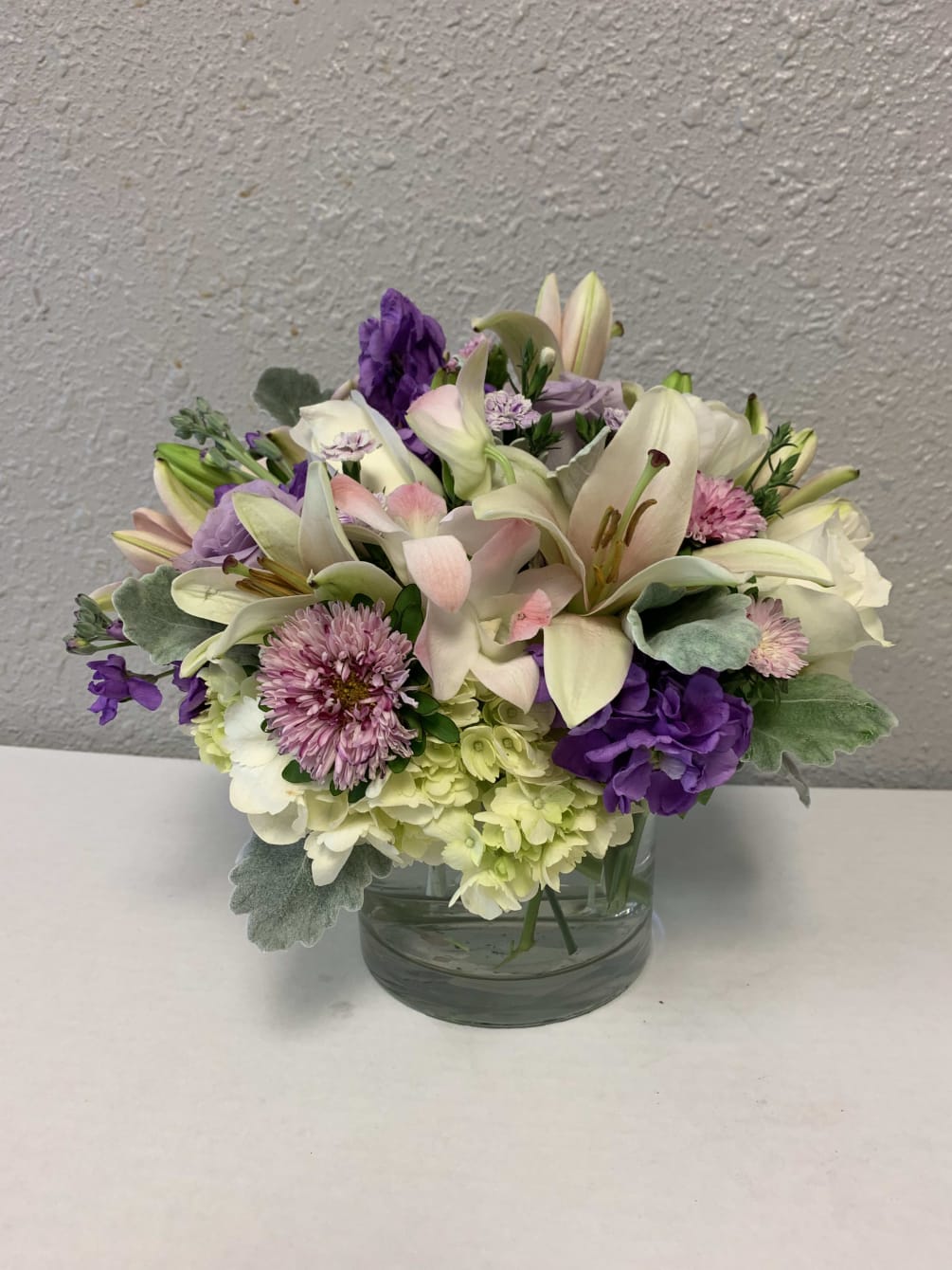This low and lush beautifully textured arrangement is perfect with its style