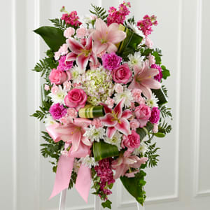 Beautiful colors and textures fill this spray with liles, roses, pom poms