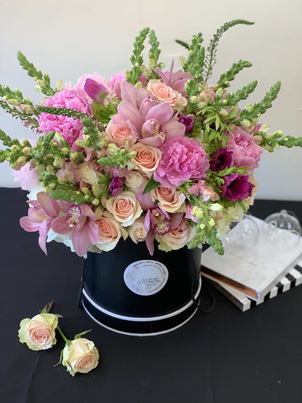 Stylish large hat box arrangement with roses, orchids, peonies and mix seasonal