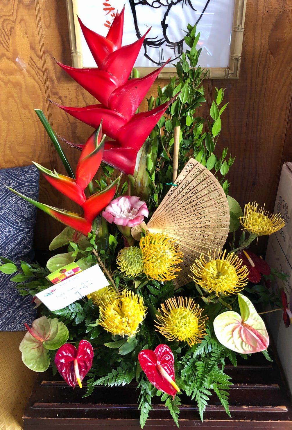 Heleconias and Pincushion Proteas accented with assorted tropical flowers and greenery. 