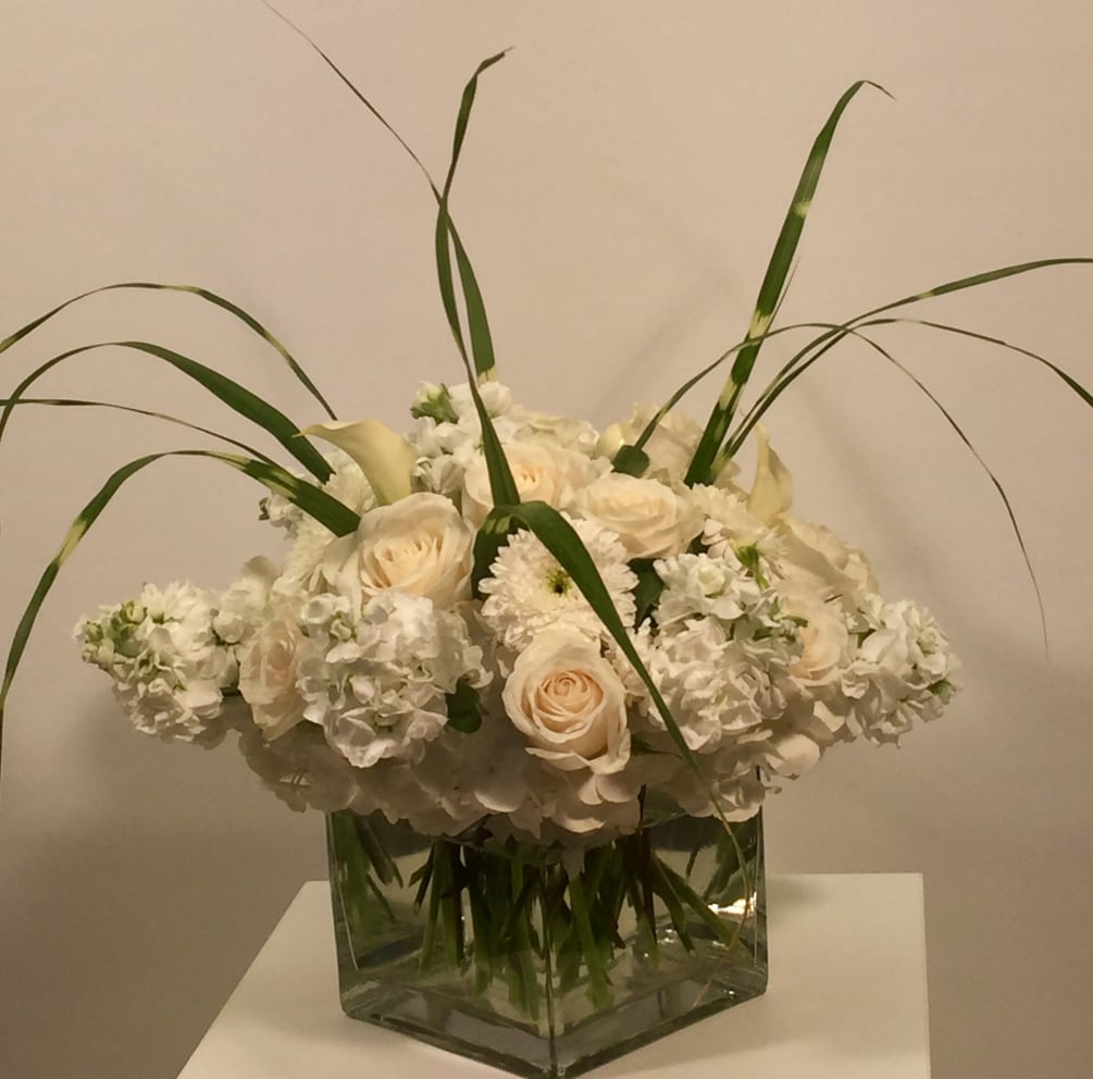 Dense Contemporary Arrangement of Seasonal Whites in a Clear Glass Cube