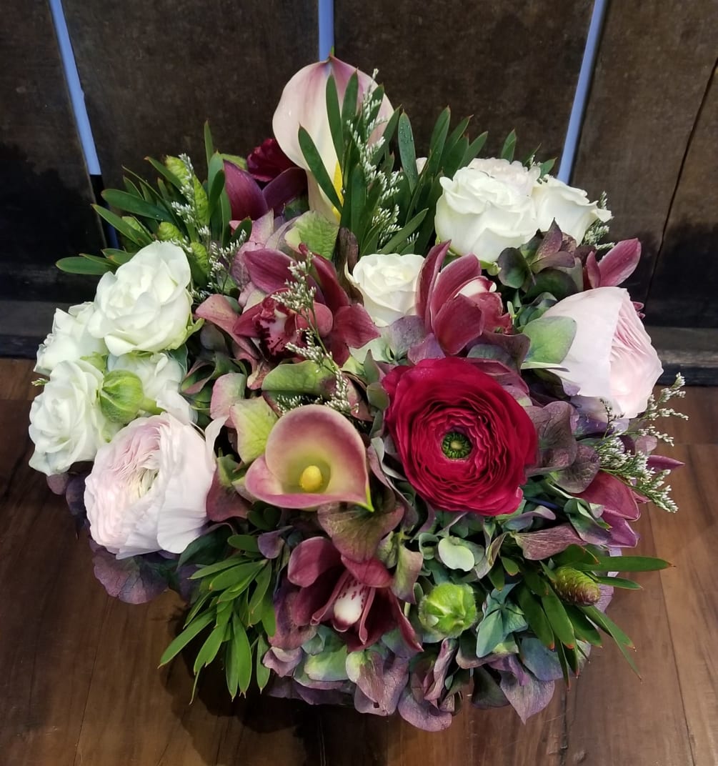 This medium sized arrangement features a variety of imported premium flowers, all