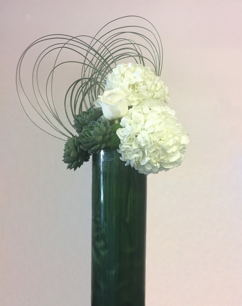Tall Modern arrangement with succulents, hydrangeas and roses.
Measures approximately 26&quot; - 28&quot;.