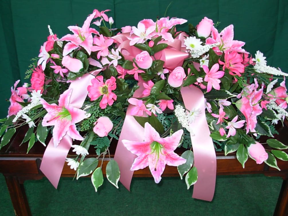 Our SILK - PERMANENT LILLY CASKET SPRAY  is made of pink