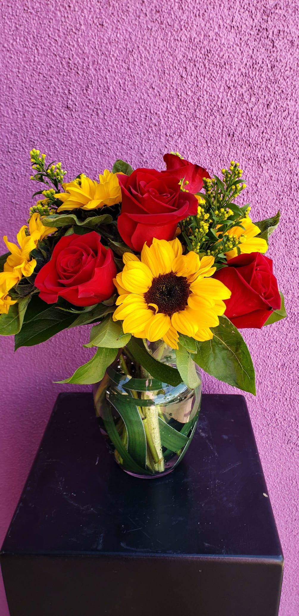 Half a dozen red roses and sunflowers