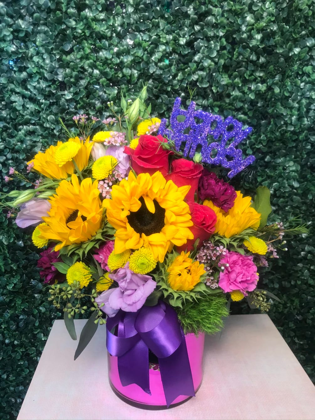 SUNFLOWERS, YELLOW BOTTON, PURPLE AND LAVANDER CARNATIONS, WITH AROMATIC EUCALYPTUS IN HOT