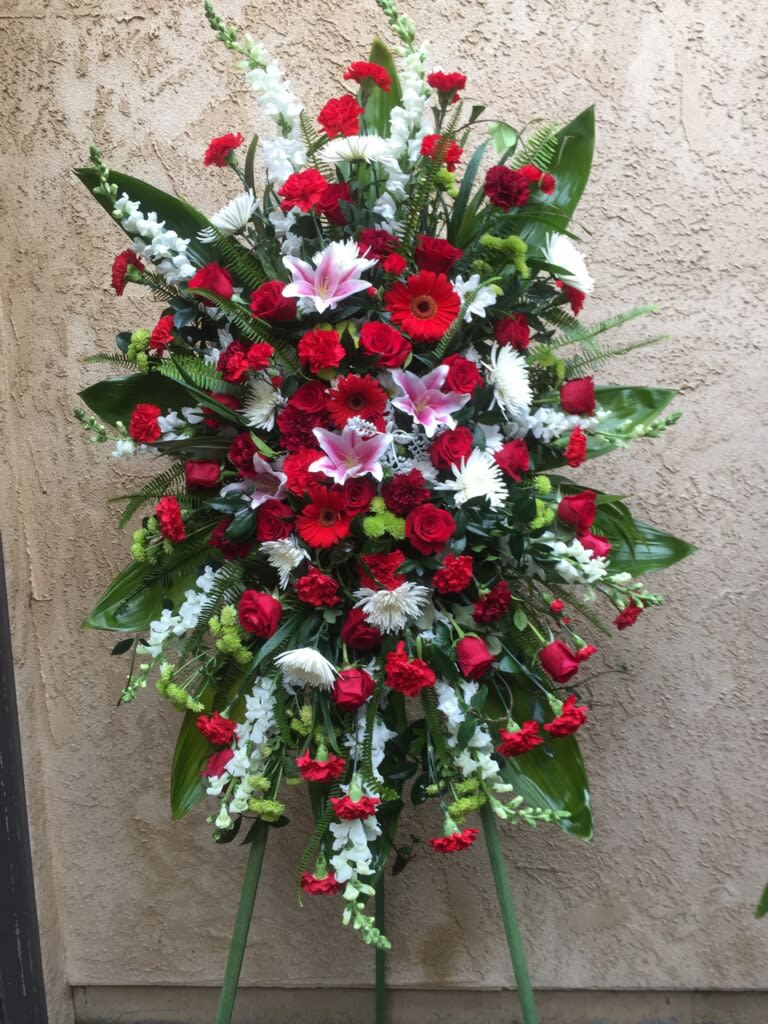 Funeral spray including red and white flowers.