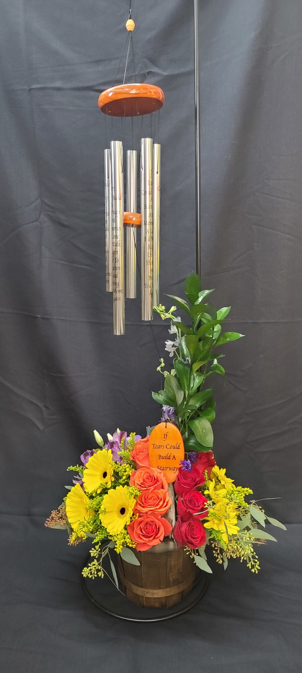Wind Chime artfully displayed in a copper container accented with roses, alstromaria