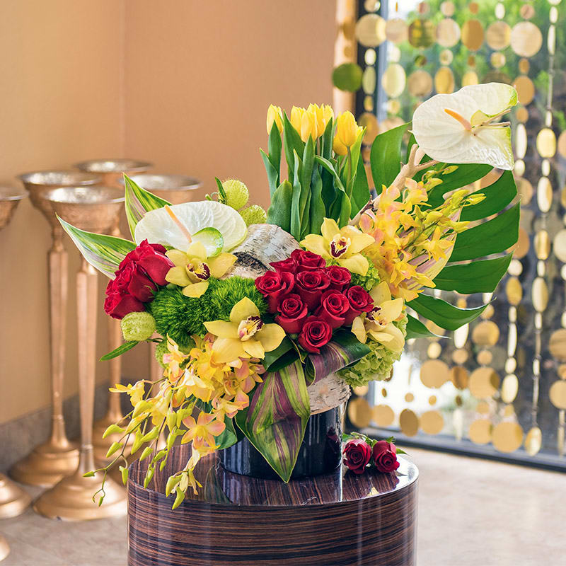 This mix of yellow and red lilies, roses, and tulips will put